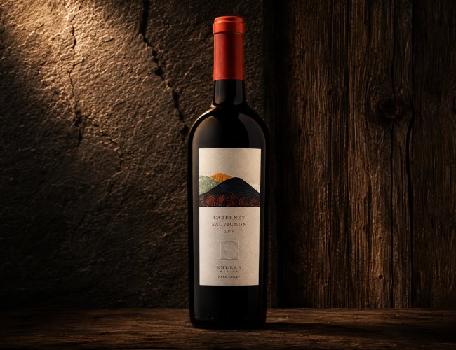 2023 Cosa Obra Rosé of Pinot Noir Sonoma County Gold Medal winner bottle and glass on a dark, moody stone background with hibiscus and orange slices. Exclusive Warehouse Discovery - 2019 Ehlers Estate Caberne